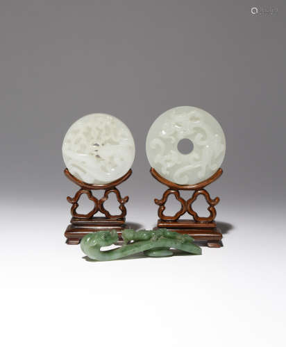 TWO CHINESE WHITE JADE BI AND A SPINACH-GREEN JADE BELTHOOK 18TH/19TH CENTURY One bi disc carved