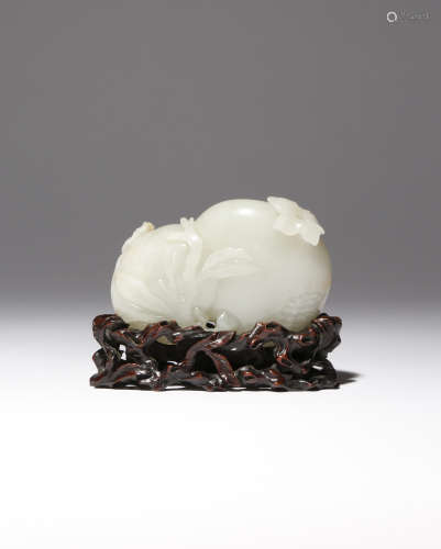 A CHINESE PALE CELADON JADE CARVING OF POMEGRANATES QIANLONG 1736-95 Formed as two fruits issuing