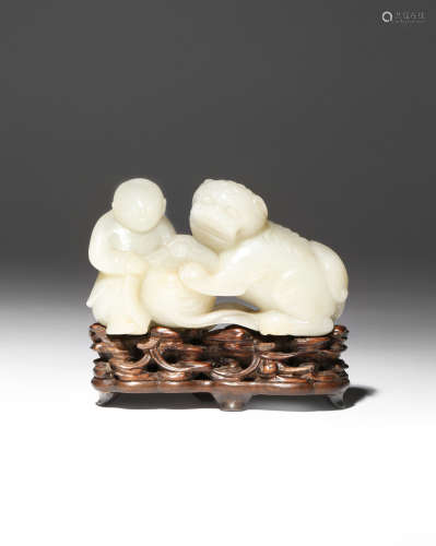 A CHINESE PALE CELADON JADE CARVING OF A BOY AND A LION DOG QIANLONG 1736-95 They crouch together