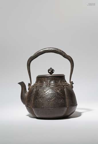 A JAPANESE CAST-IRON KETTLE AND COVER, TETSUBIN MEIJI PERIOD, 19TH CENTURY The lobed body cast in