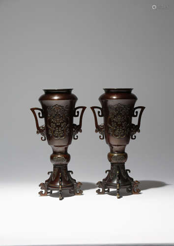 A PAIR OF JAPANESE BRONZE VASES MEIJI PERIOD, 19TH CENTURY The tall bodies raised on four feet