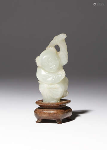 A SMALL CHINESE PALE CELADON JADE CARVING OF A BOY QING DYNASTY The smiling child depicted