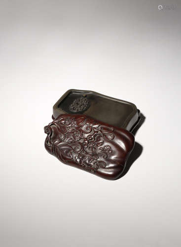 A CHINESE DUAN STONE INKSTONE CONTAINED IN A WOOD BOX AND COVER 19TH/20TH CENTURY The stone carved