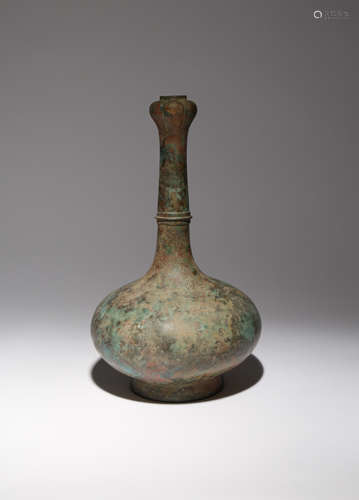 A CHINESE BRONZE GARLIC-MOUTH BOTTLE VASE HAN DYNASTY The compressed body surmounted by a tall