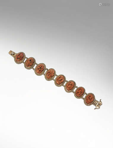 A CHINESE SILVER BRACELET SET WITH CARVED OLIVE STONES 19TH/EARLY 20TH CENTURY With eight oval