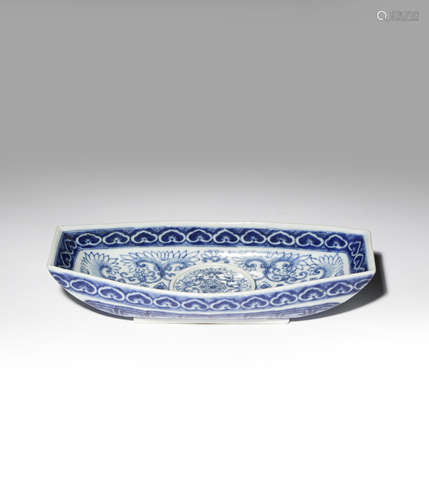 A CHINESE BLUE AND WHITE INGOT-SHAPED CUP STAND 19TH CENTURY Painted with flowers and stylised