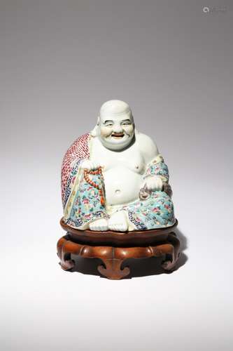 A LARGE CHINESE FAMILLE ROSE FIGURE OF BUDAI HE SHANG EARLY 20TH CENTURY He sits in a relaxed pose