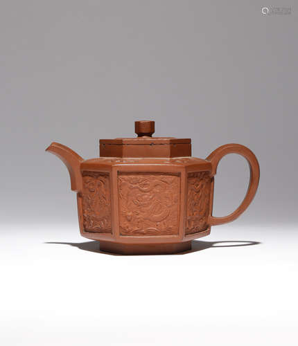 A CHINESE YIXING HEXAGONAL-SECTION 'DRAGON AND PHOENIX' TEAPOT AND COVER EARLY 18TH CENTURY The body