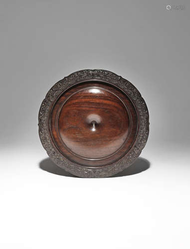 A CHINESE HARDWOOD CIRCULAR STAND 18TH CENTURY Carved with a gently raised dome recessed in the