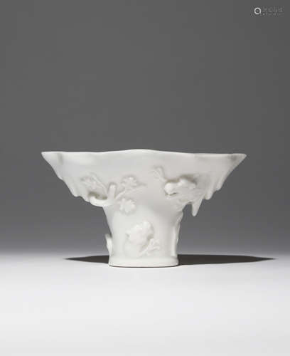 A CHINESE BLANC DE CHINE LIBATION CUP 17TH CENTURY Shaped as a rhinoceros horn cup, moulded in