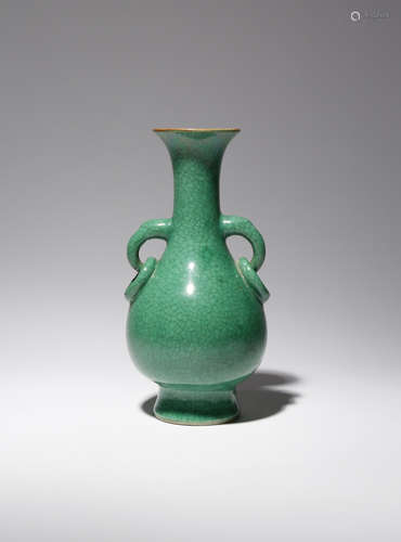 A CHINESE GREEN GLAZED PEAR-SHAPED VASE LATE QING DYNASTY Rising from a spread foot to a tall