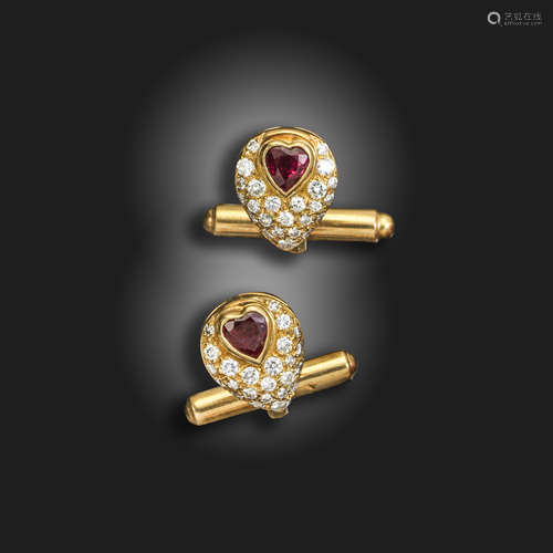 A pair of ruby and diamond-set gold cufflinks, each link centred with a heart-shaped ruby, with