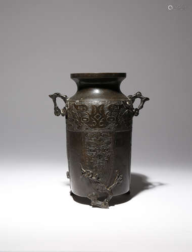 A CHINESE ARCHAISTIC BRONZE VASE MING DYNASTY The tall cylindrical body surmounted by a short