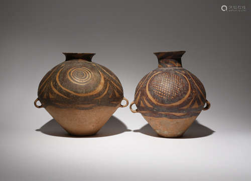 TWO CHINESE POTTERY VASES NEOLITHIC Each surmounted by a waisted neck and tapering towards the foot,