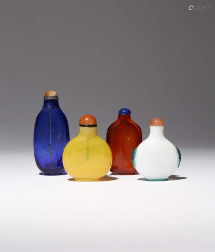 FOUR CHINESE GLASS SNUFF BOTTLES 18TH/19TH CENTURY The largest of a dark blue colour and with a