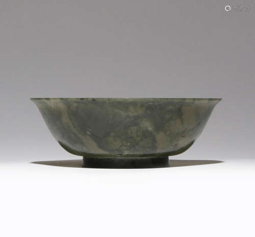 A CHINESE SPINACH-GREEN JADE BOWL 18TH/19TH CENTURY The plain body carved with a gently flaring rim,