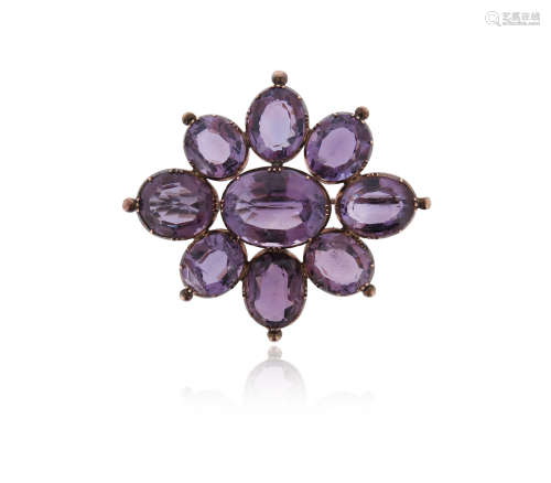 A Victorian amethyst brooch pendant, of flowerhead form, set with oval-shaped amethysts in silver