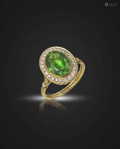 A demantoid garnet and diamond cluster ring, the oval-shaped demantoid garnet weighs 3.13cts, set