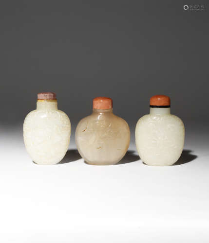 THREE CHINESE SNUFF BOTTLES 19TH CENTURY One carved in pale celadon jade with stylised flowerheads