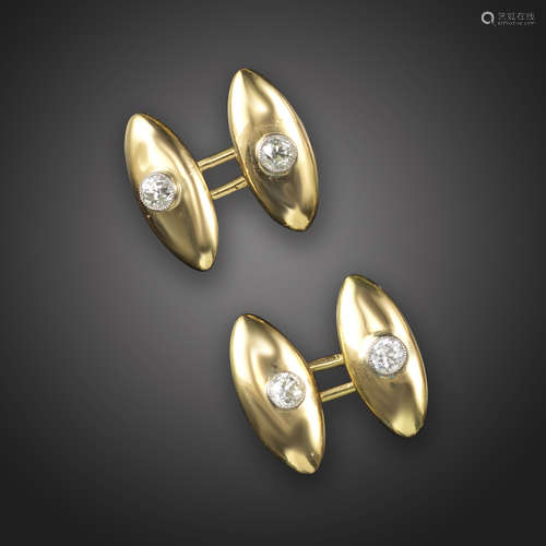 A pair of torpedo-shaped gold cufflinks, each link set with an old circular-cut diamond millegrain