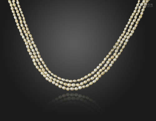 A three-row natural pearl necklace, the pearls graduate from 3.2 - 5.2mm and are set with a