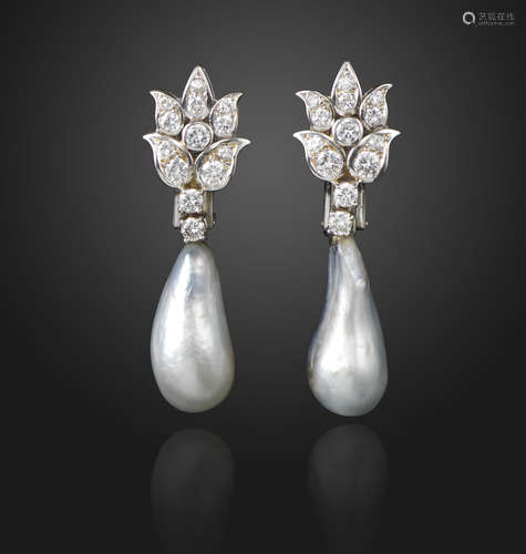 A pair of natural pearl and diamond drop earrings, the pearls suspend from foliate upper sections