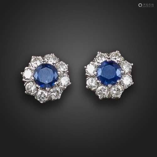 A pair of sapphire and diamond cluster earrings, the circular-cut sapphires are set within a