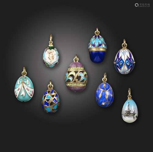 Eight silver-gilt and enamel miniature egg pendants, of various designs and decoration colours,