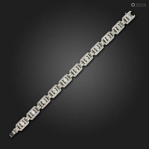 A diamond-set platinum bracelet, the openwork rectangular links are pavé-set with graduated round