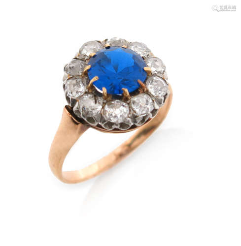 A French blue stone and diamond cluster ring, the synthetic blue stone set within a surround of