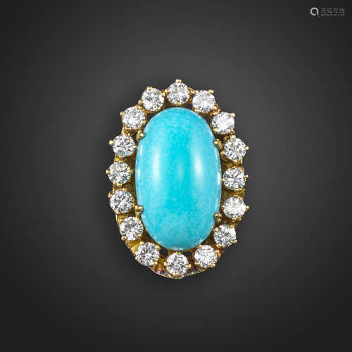 A turquoise and diamond cluster ring, the oval turquoise cabochon is set within a surround of