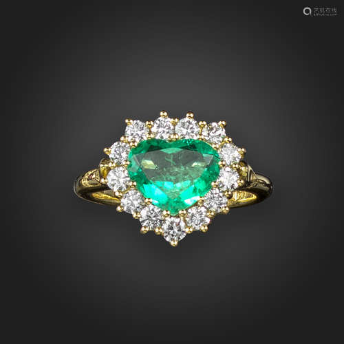 An emerald and diamond heart-shaped cluster ring, the heart-shaped emerald is set within a