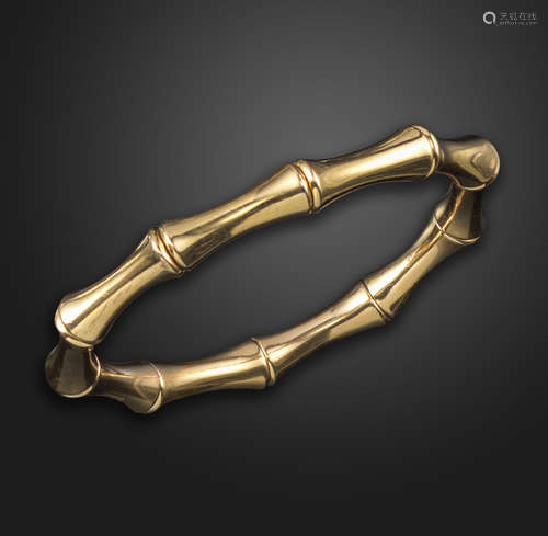 A gold 'bamboo' bangle by Gucci, the expanding bracelet with polished gold links in the form of