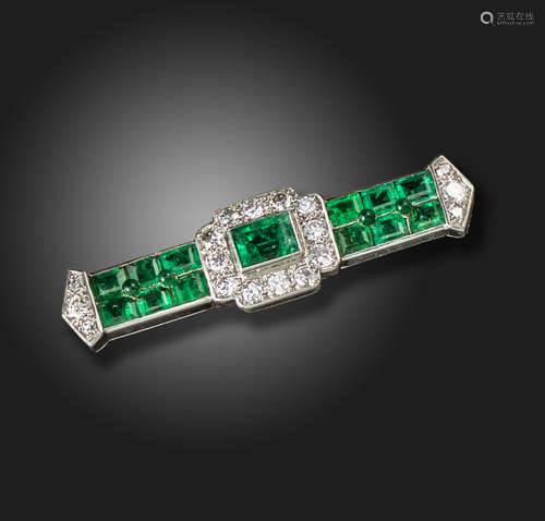 An Art Deco emerald and diamond brooch by Cartier, set with a rectangular emerald within tapered