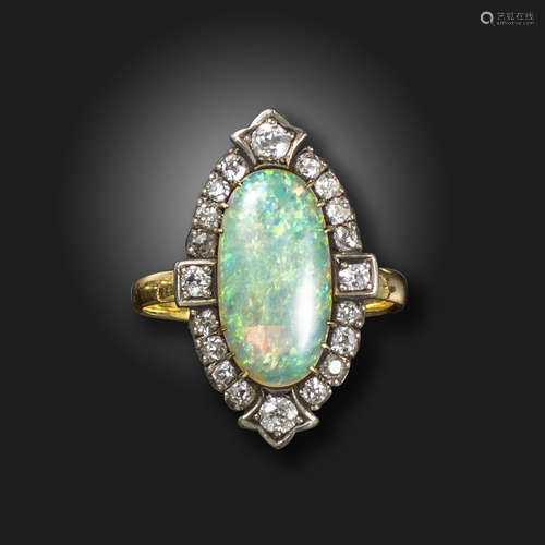 An opal and diamond cluster ring, the oval opal cabochon set within a surround of old cushion-shaped