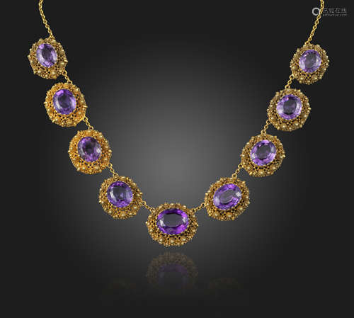 A Regency composite amethyst and gold necklace, the graduated oval-shaped amethysts are set within