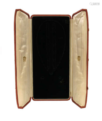 A leather fitted parure case by Cartier, the centre-opening box with fitted sections for a necklace,