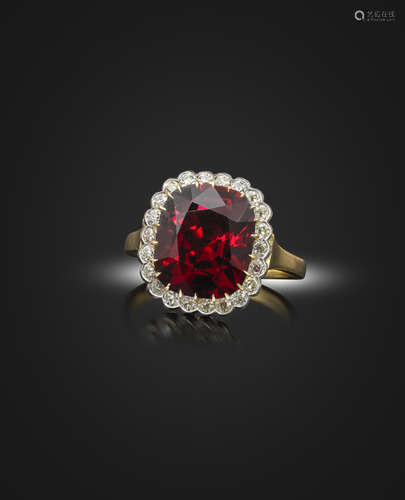 A spinel and diamond cluster ring, the cushion-shaped red spinel weighs 5.60cts, set within a