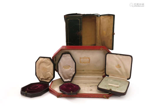 A collection of jewellery boxes by Cartier and Giuliano, including a green leather centre-opening