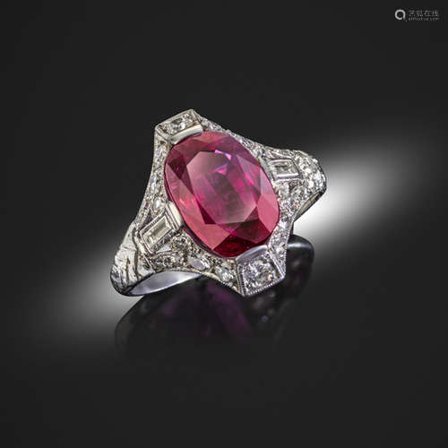 An early 20th century ruby and diamond-set platinum ring, the oval-shaped ruby weighs 6.61cts and is