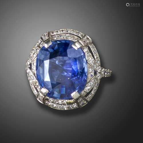 A sapphire and diamond cluster ring, centred with a cushion-shaped sapphire weighing 12.97cts, in an