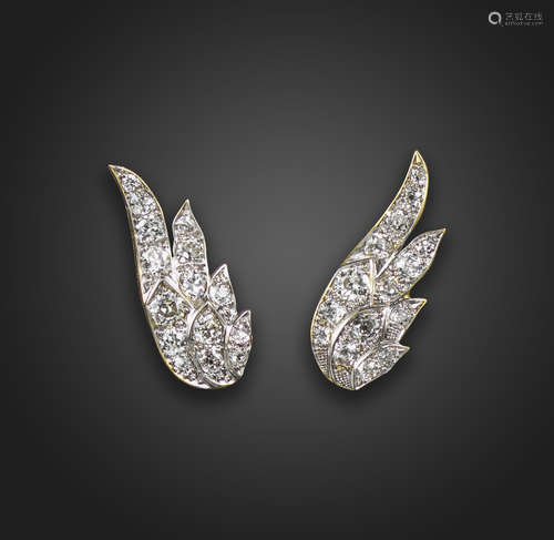 A pair of diamond-set earrings, in the form of stylised wings, set with graduated circular-cut