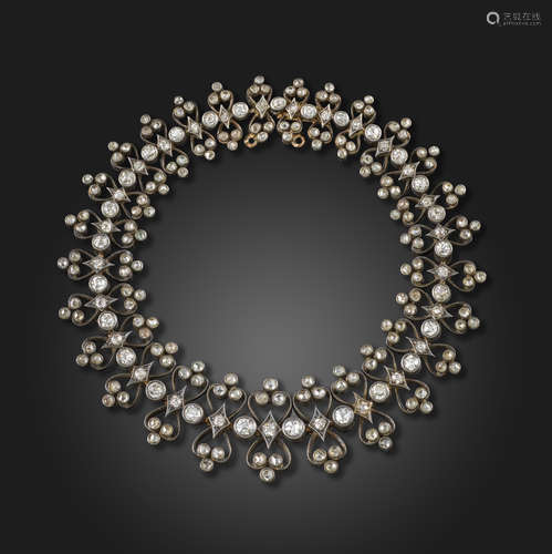 A late 19th century diamond bracelet, set with graduated old circular-cut diamonds, between openwork