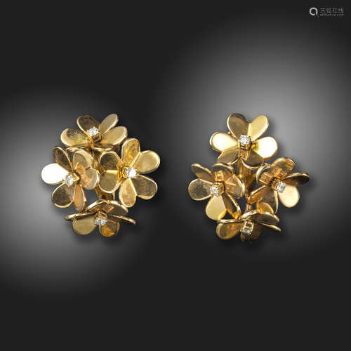 A pair of diamond-set gold foliate earrings, each rotating flowerhead centred with a round