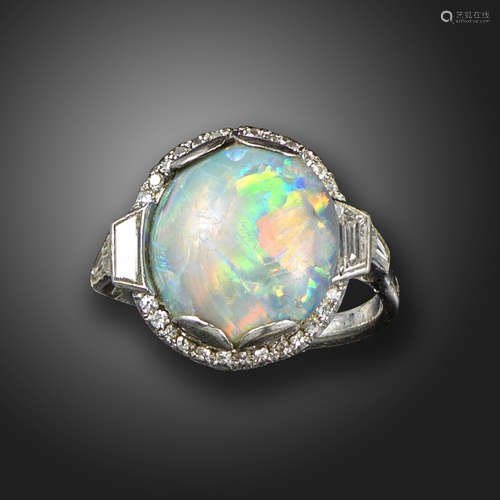 An Art Deco opal and diamond cluster ring, the oval-shaped opal set within a surround of small