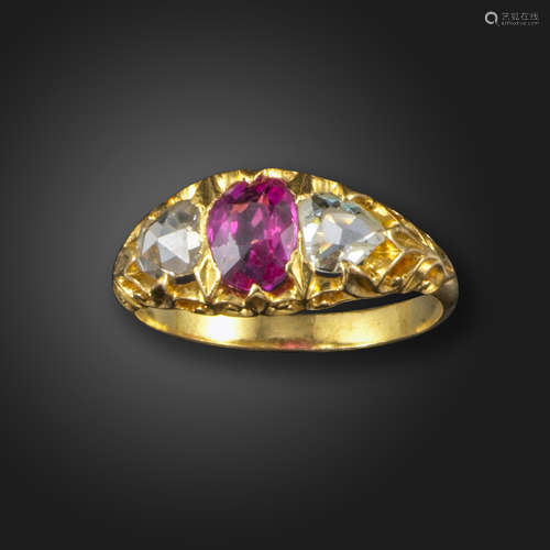 A pink sapphire and diamond three stone ring, the oval-shaped pink sapphire set with rose-cut