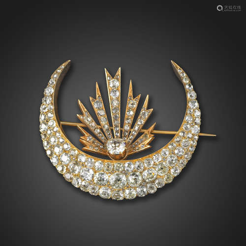 A Victorian closed crescent brooch, set with graduated old cushion-shaped diamonds in gold, with a