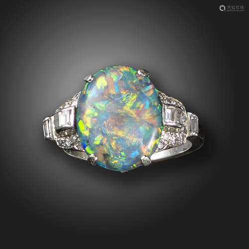 An Art Deco opal and diamond ring, the solid black opal within shoulders set with baguette-shaped