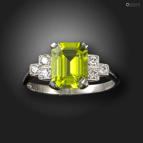 A peridot and diamond ring, set with an emerald-cut peridot with round brilliant-cut shoulder