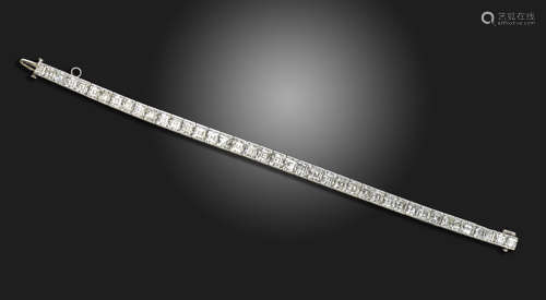 A slightly graduated diamond line bracelet, c.1925, the square-shaped diamonds channel-set in